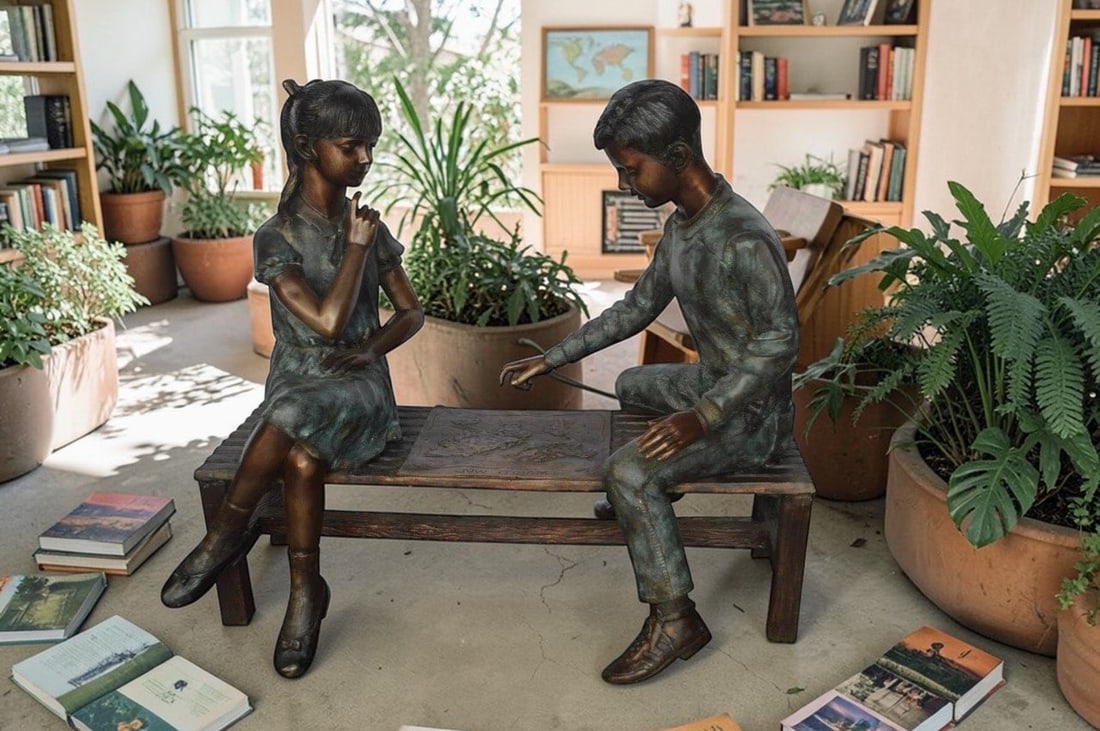 Young Couple Reviewing a World Map Bronze Statue - Size: 32"L x 47"W x 42"H. - 4