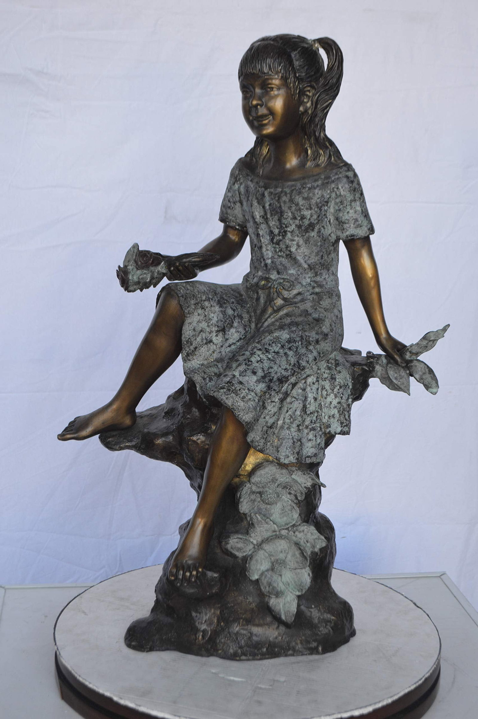Girl on Tree Trunk Holding Flowers Bronze Statue - Size: 26"L x 11"W x 36"H. - 10