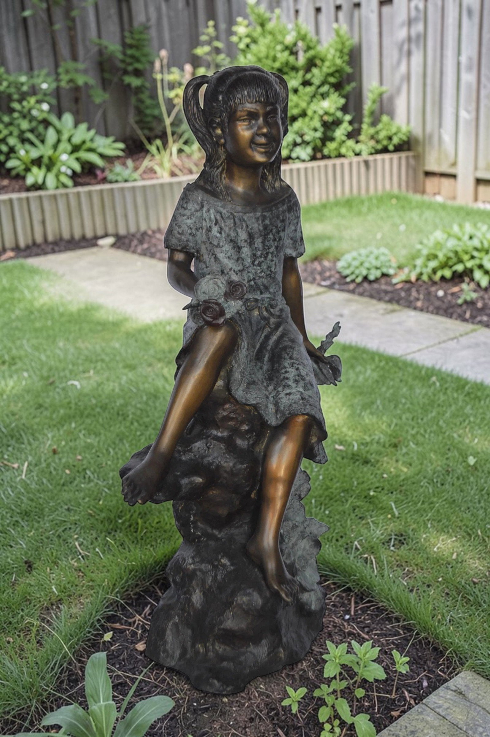 Girl on Tree Trunk Holding Flowers Bronze Statue - Size: 26"L x 11"W x 36"H. - 4