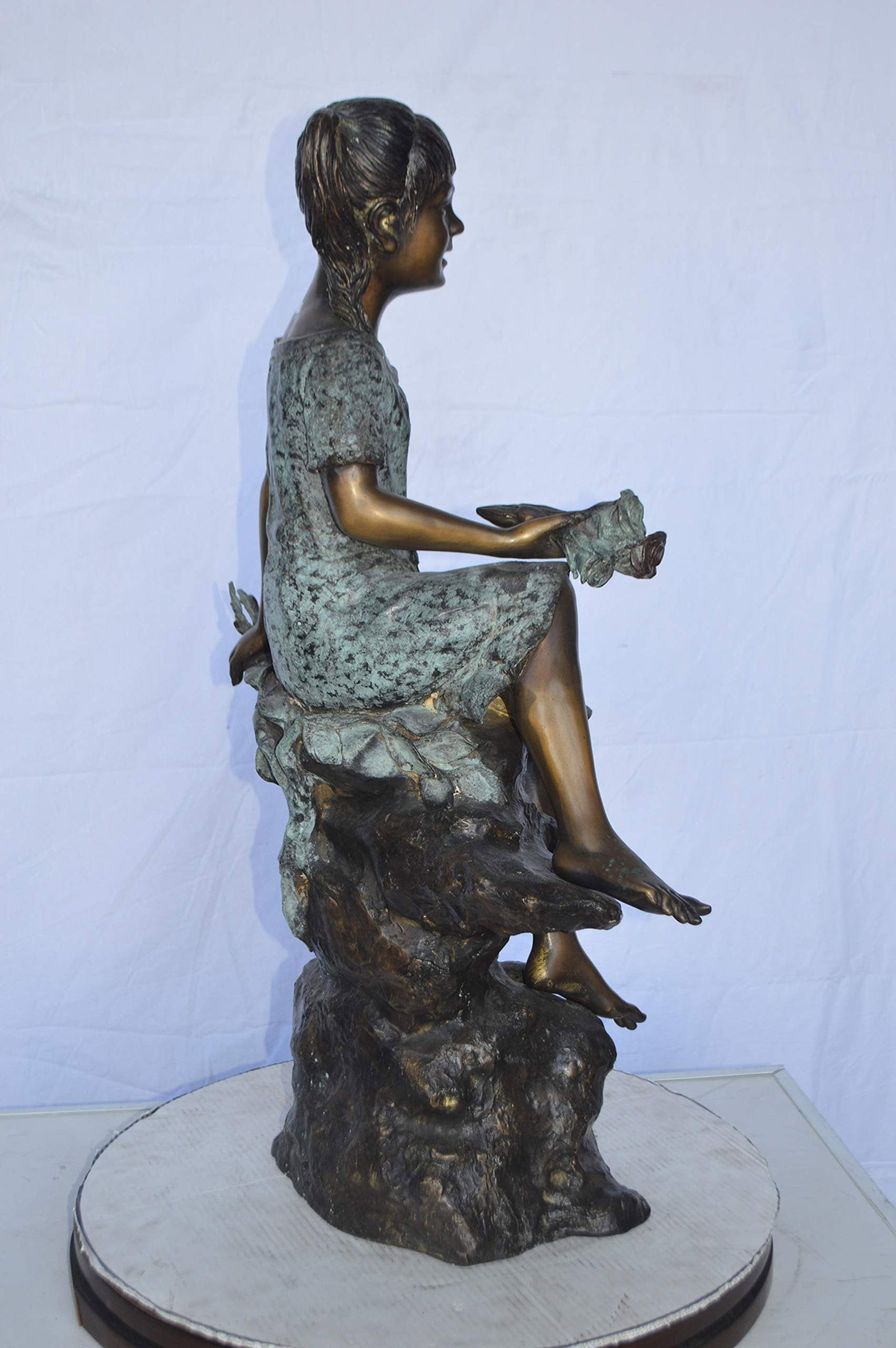Girl on Tree Trunk Holding Flowers Bronze Statue - Size: 26"L x 11"W x 36"H. - 6