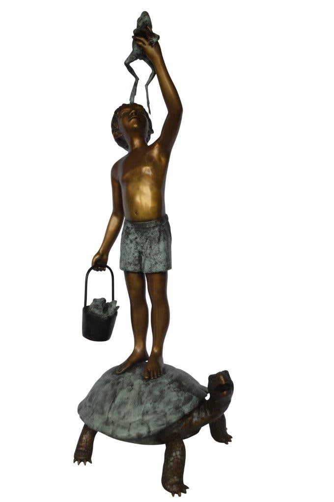 Boy on turtle holding frog bronze fountain statue - Size: 24"L x 18"W x 55"H.: Title:Boy on turtle holding frog bronze fountain statue - Size: 24"L x 18"W x 55"H. Description:This young boy is holding a frog in his hand, and he is clearly in a joyous pose on the back of the