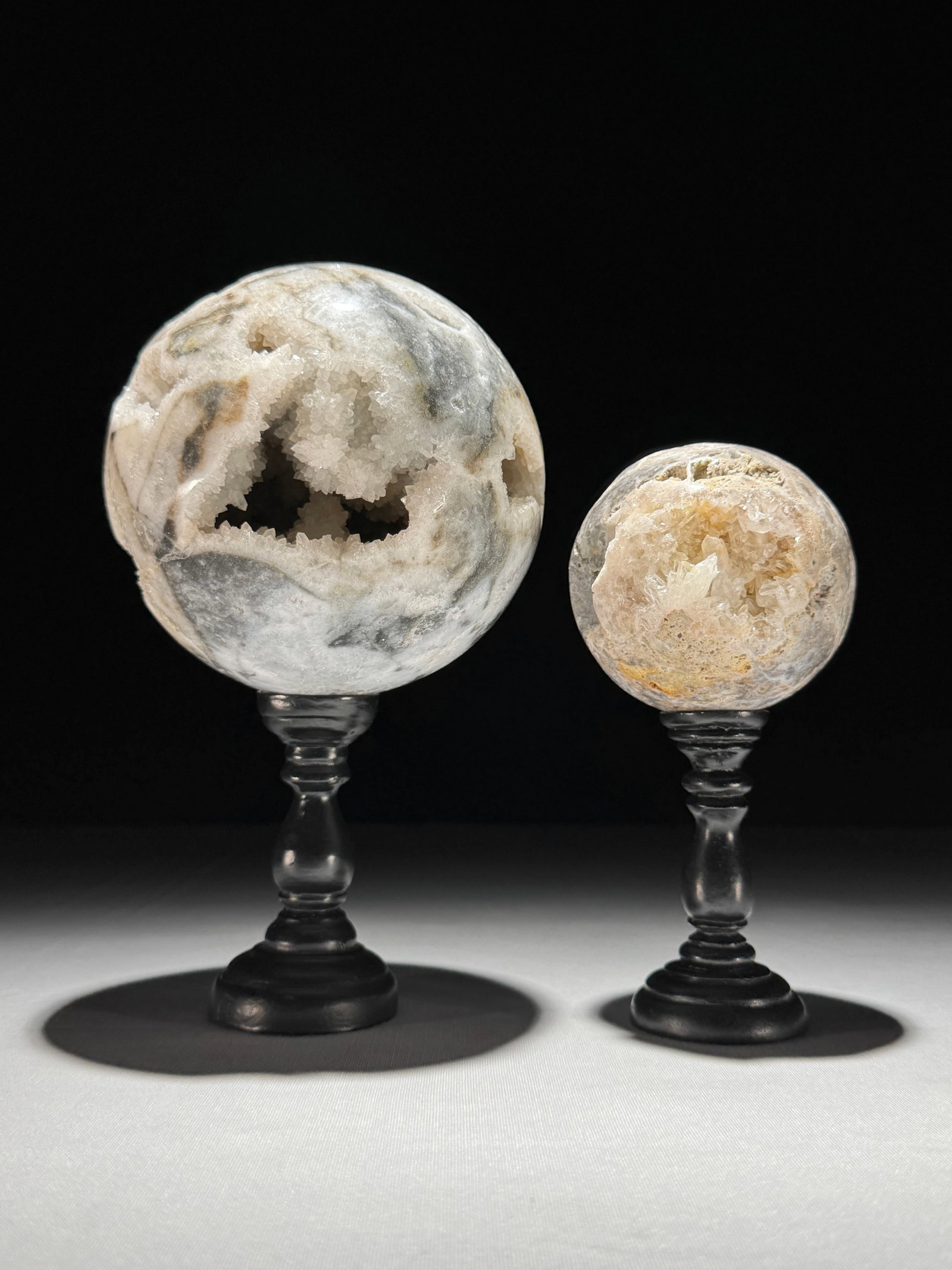 Wonderful set of 2 crystal spheres with stands: Title: Unique slice of red petrified wood on a custom stand Maker:Unknown Origin: Indonesia Date/Period:NEOGENE-Miocene, Aquitanian (20.44–23.03 million years) Materials:Petrified Wood, steel Dimens