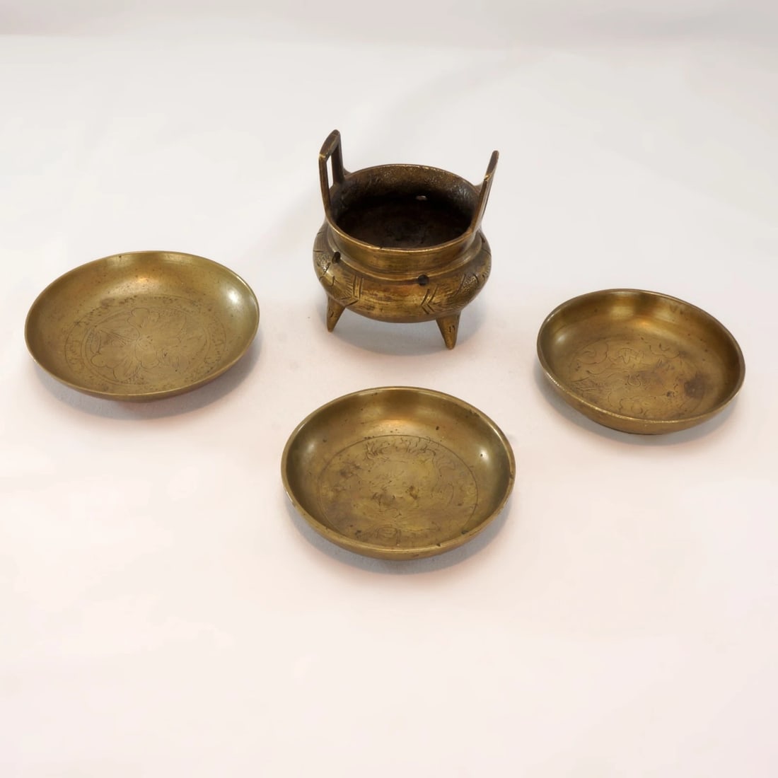 1920s Chinese Brass Censer, Saucers/Coasters: Title:1920s Chinese Brass Censer, Saucers/Coasters Size:Censer 2 ½ in (6.4 cm) diameter x 3 in (7.6 cm) tall Larger dish – 3 3/8 in (8.4 cm) diameter x 7/16 in (1.1 cm) tall Two smaller