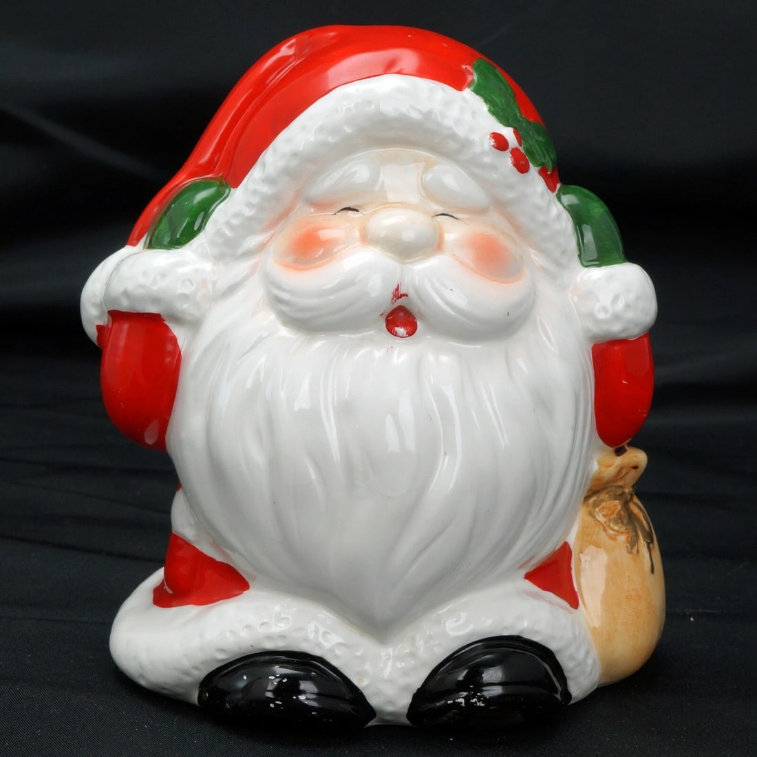 Vintage Ceramic Santa Claus Bank: Title:Vintage Ceramic Santa Claus Bank Size:4 ½ in (11.4 cm) tall x 4 ¾ in (12.1 cm) wide x 4 in (10.2 cm) deep. Description:A fun, colorful and nostalgic Christmas coin bank in the shap