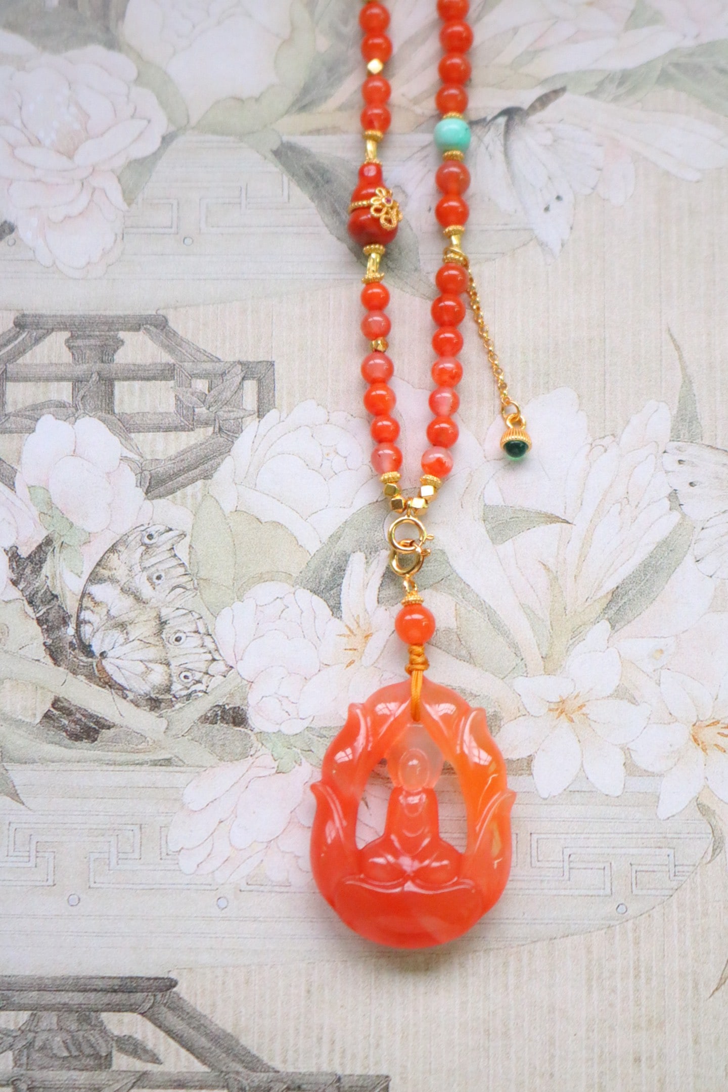 Nanhong Agate Hand Carved Buddha Pendant: Title: Nanhong Agate Hand Carved Buddha Pendant Origin: Chinese Date/Period: After2026 Materials: Nanhong Agate Dimensions: 34.5x25x8.2(mm) 1.36x0.98x0.32(inches) Reserve: $196.00 Shipping: Domestic: