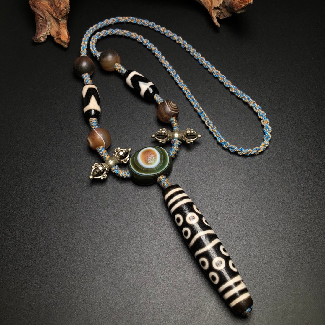 Old Tibetan Thirteen Eyes DZI Agate Pendant: Title: Old Tibetan Thirteen Eyes DZI Agate Pendant Origin: Chinese Date/Period: After1910 Materials: DZI Agate Dimensions: 80x17(mm) 3.15x0.67(inches) 29x13(mm) 1.14x0.51(inches) Reserve: $179.00