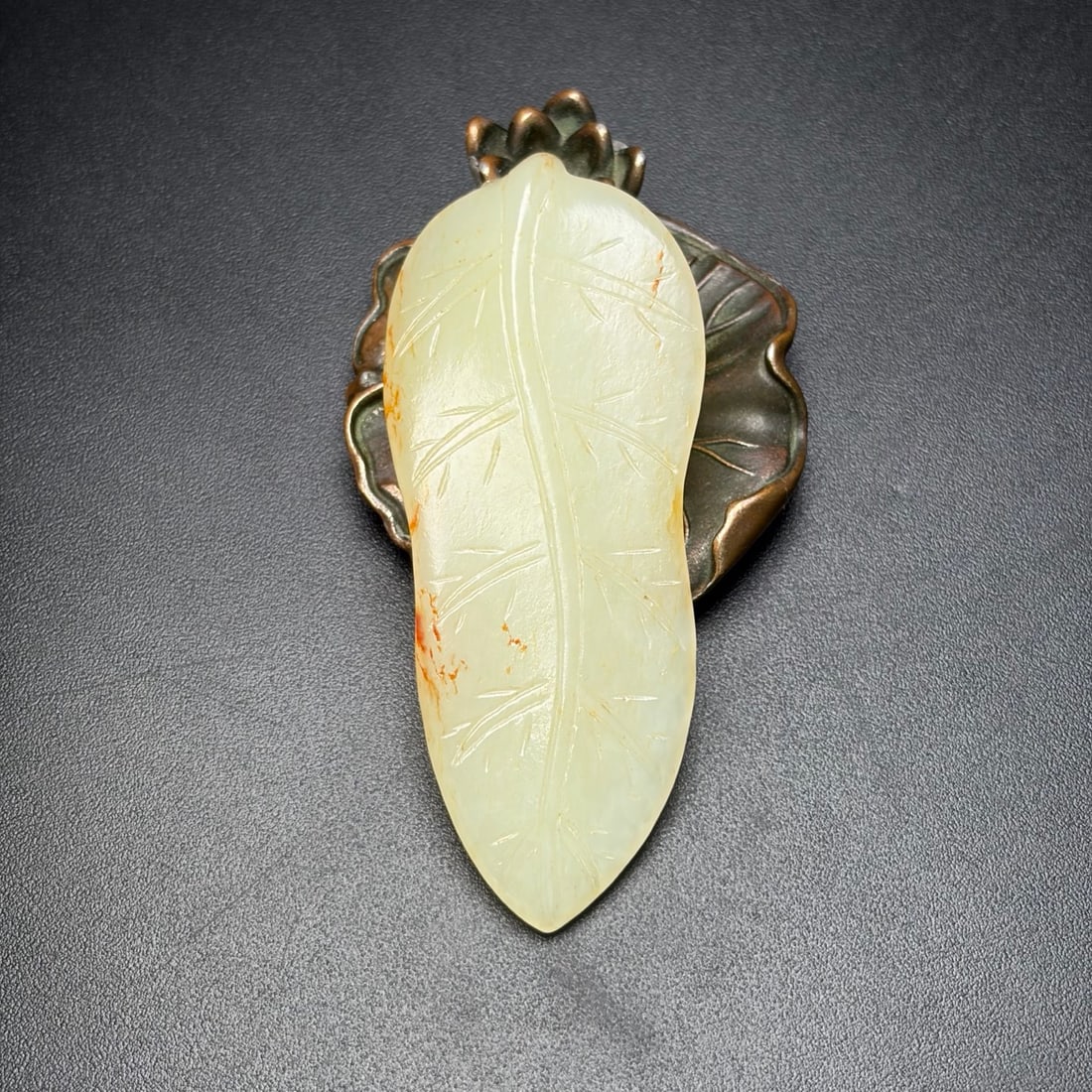 Hetian Jade Leaf Pendant: Title: Hetian Jade Leaf Pendant Origin: Chinese Date/Period: After1900 Materials: Hetian Jade Dimensions: 77x32x10(mm) 3.03x1.26x0.39(inches) Weight 0.06 lbs/27g Reserve: $180.00 Shipping: Domestic: