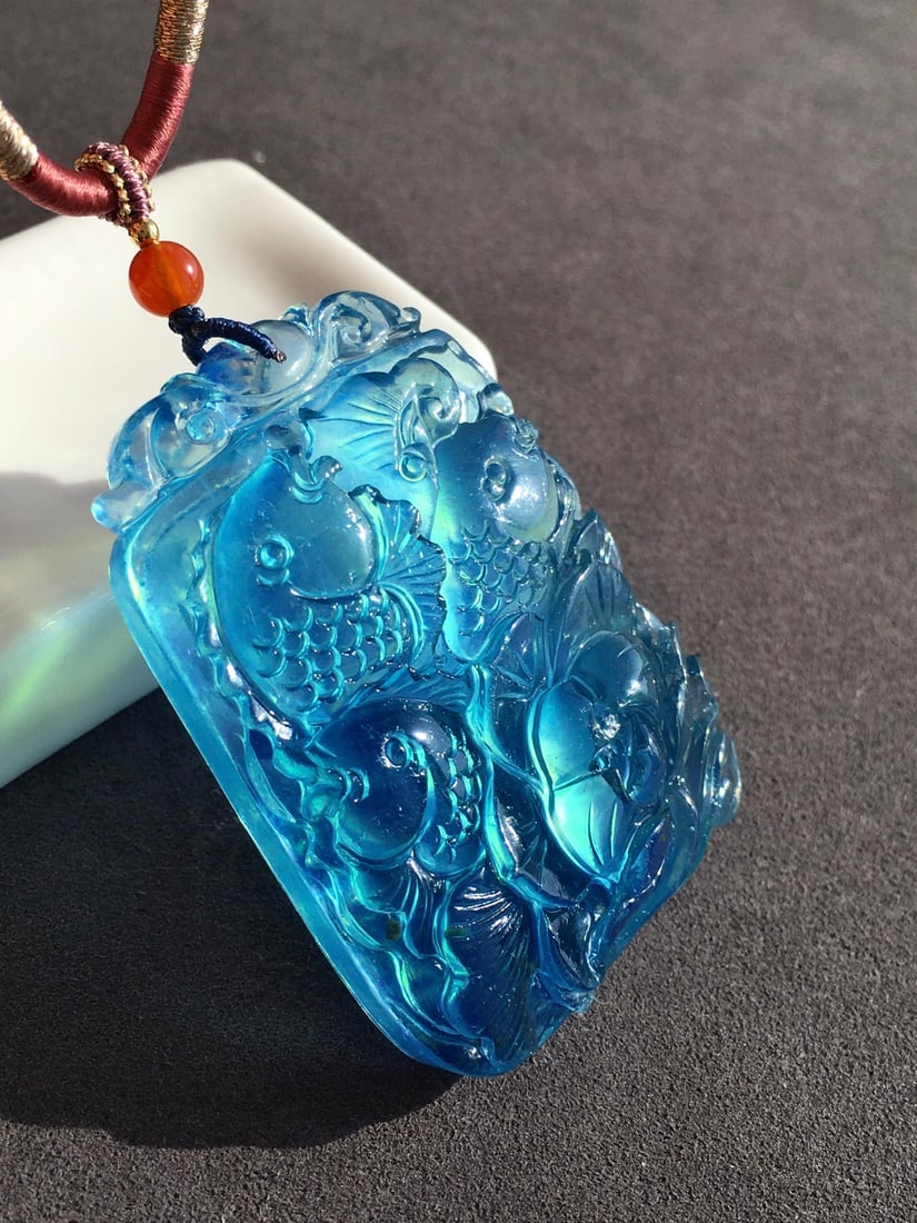 Natural Aquamarine Hand Carved Fish Lotus Pendant: Title: Natural Aquamarine Hand Carved Fish Lotus Pendant Origin: Chinese Date/Period: After2020 Materials: Aquamarine Dimensions: 52.2x36.6x13.5(mm) 2.06x1.44x0.53(inches) Weight 0.10 lbs/44.12g Reser