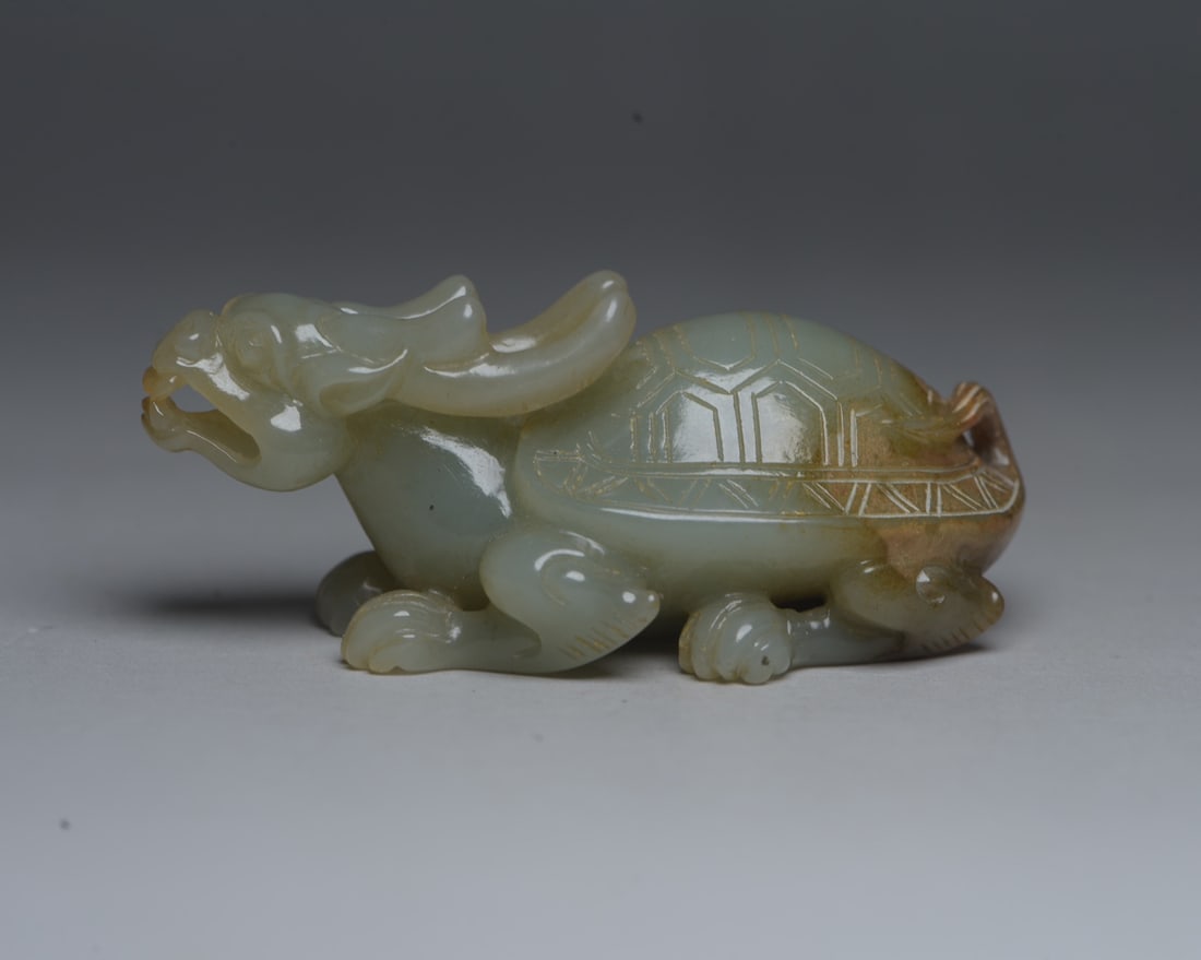 Hetian Jade Hand Carved Dragon Turtle Statue Pendant: Title: Hetian Jade Hand Carved Dragon Turtle Statue Pendant Origin: Chinese Date/Period: After1900 Materials: Hetian Jade Dimensions: 69x32x28(mm) 2.72x1.26x1.10(inches) Weight 0.15 lbs/66g Reserve: $
