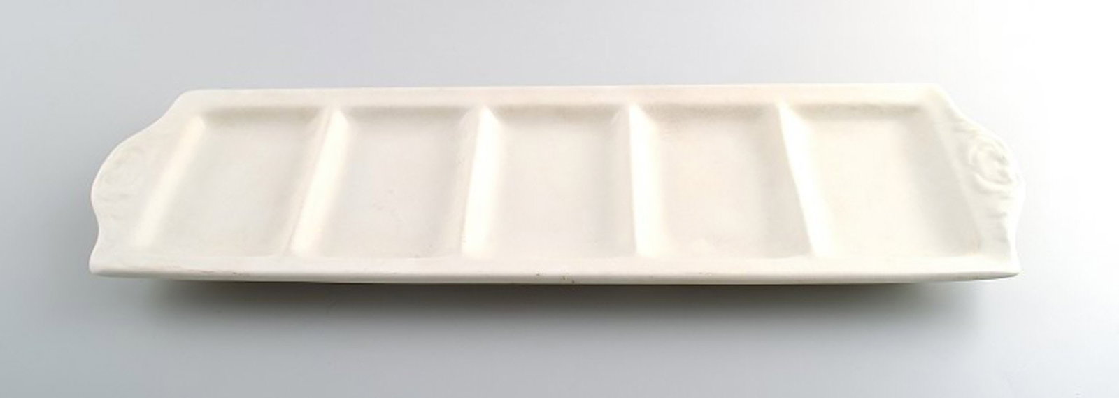 Large Rorstrand "Perl" cabaret dish in white earthenware.: Title: Large Rorstrand "Perl" cabaret dish in white earthenware. Description: Large Rorstrand "Perl" cabaret dish in white earthenware. Measures 46.5 cm. X 14 cm. Marked. In perfect condition.; Large 