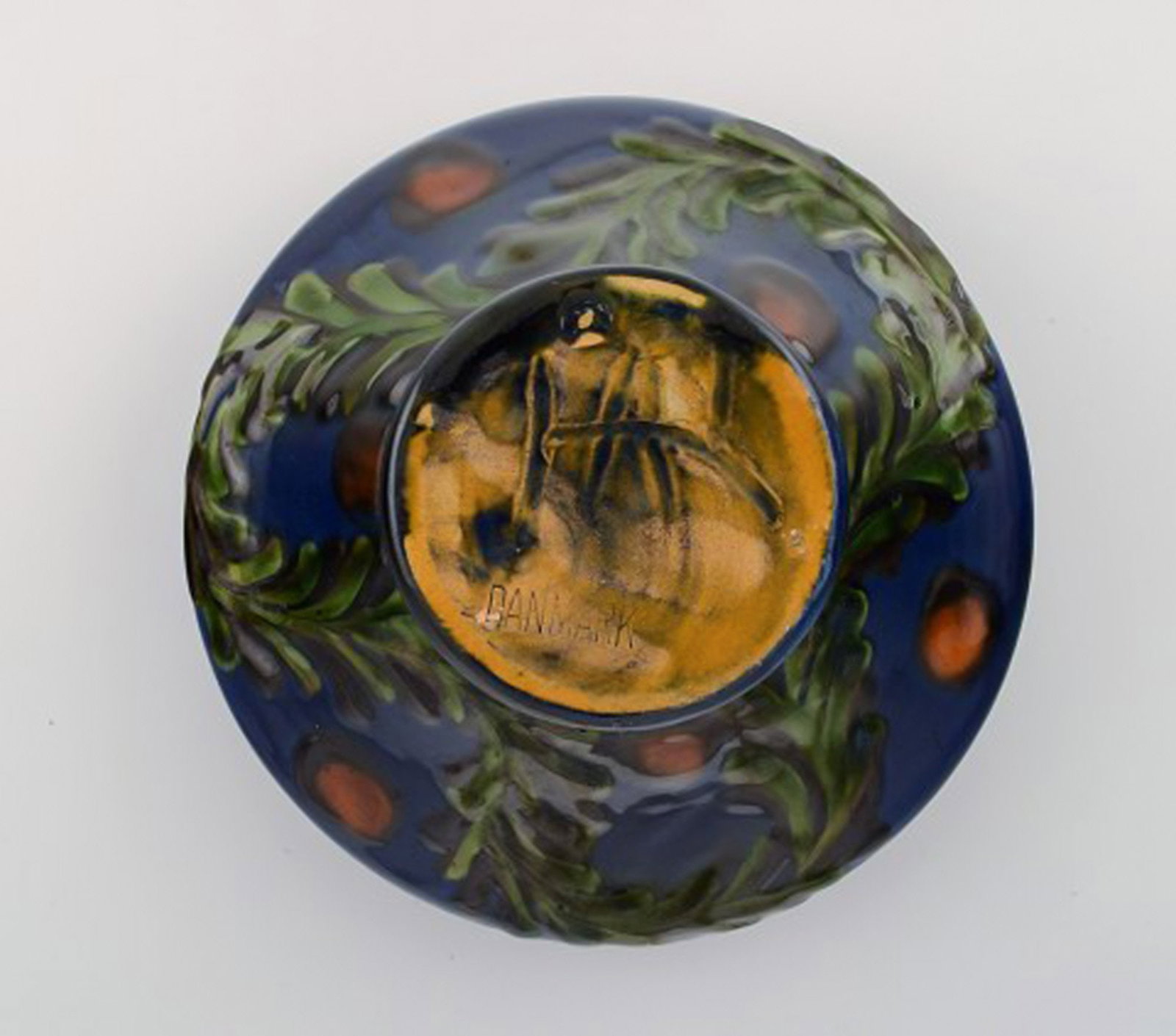 Kahler, Denmark. Bowl in glazed ceramics. Green leaves and red berries on a dark blue background. - 7