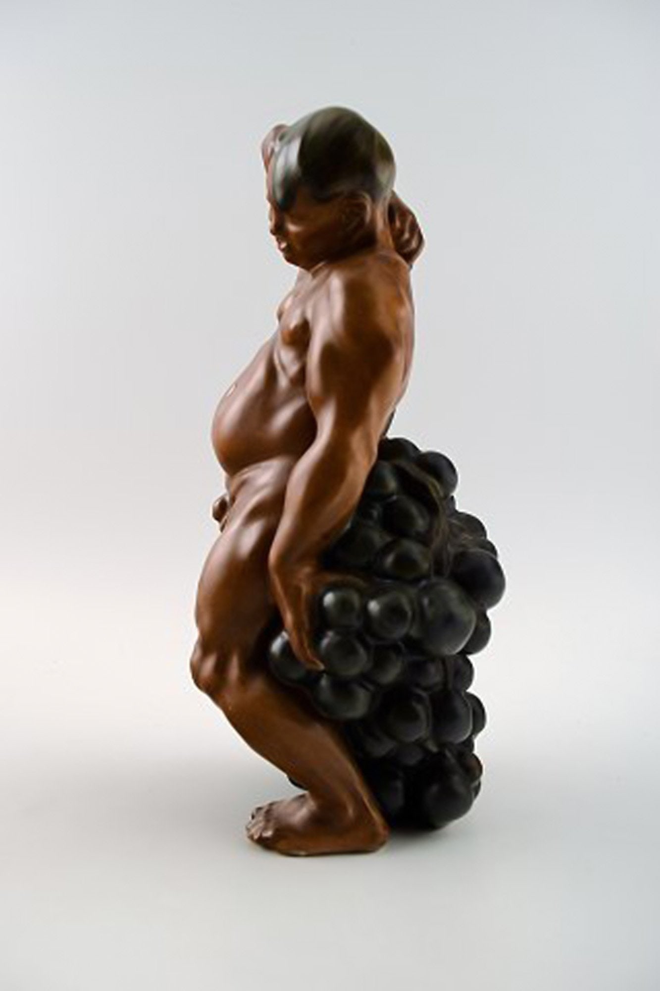Bing & Grondahl Figurine of a man standing with grapes by Kai Nielsen. Model number 4025. From the - 4