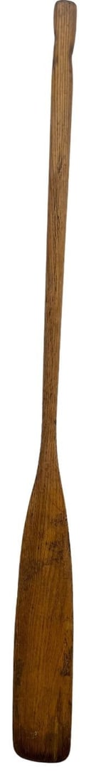 Vintage Wooden Canoe Paddle: A vintage wooden single-blade canoe paddle (oar), likely crafted in the mid-20th century. The paddle features a rich, aged wood grain with a slightly darkened patina, indicative of its age and use.