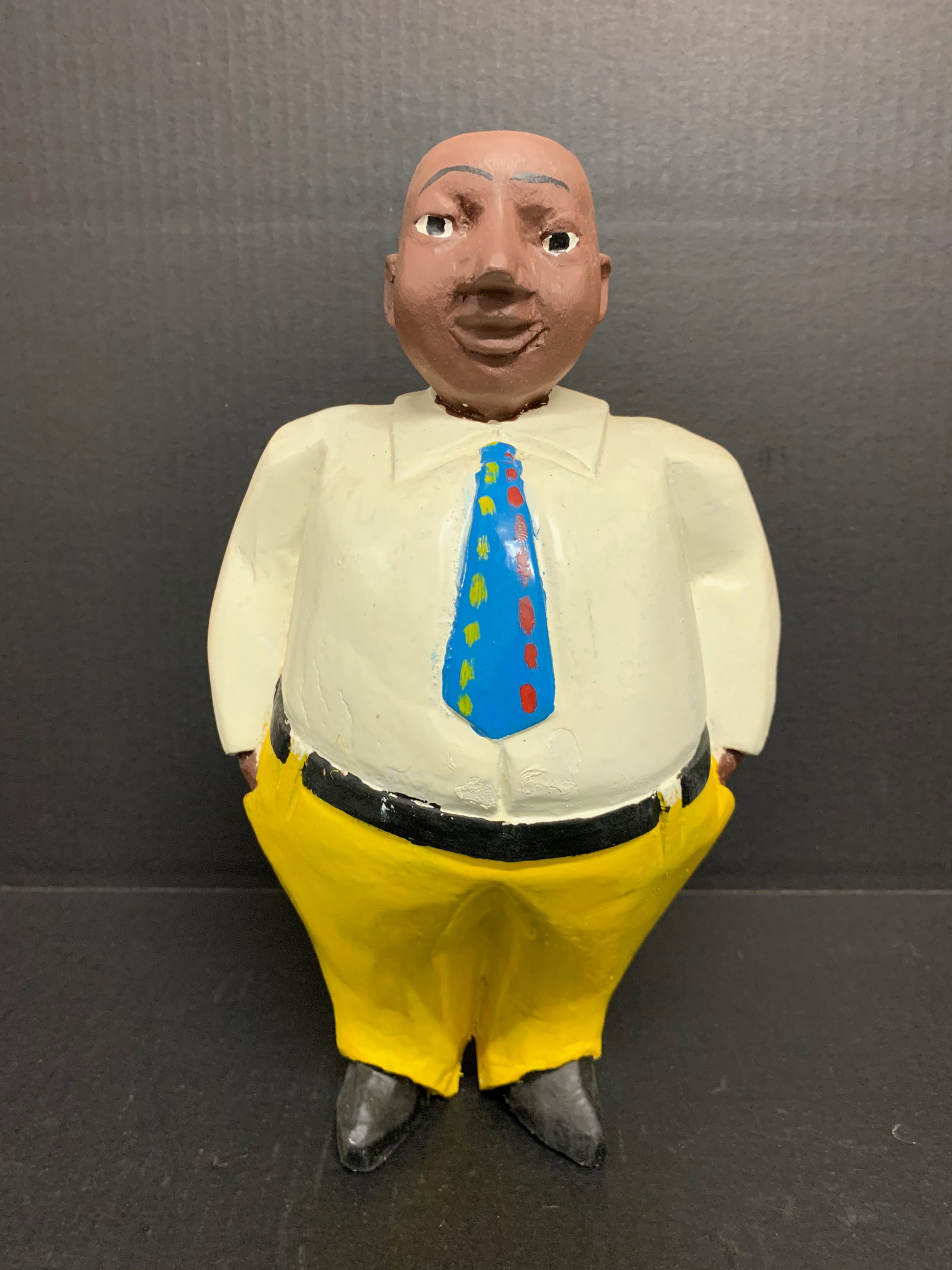 African Tribal Art Carved Wood Colonial Male Statue: Title: Collonial Male Statue Date/Period: Late 20th Century Materials: Wood Size: 13.75" h x 7.5" w Reserve: $80.00 Shipping: Domestic: Flat-rate of $30.00 to anywhere within the contiguous U.S. Inter