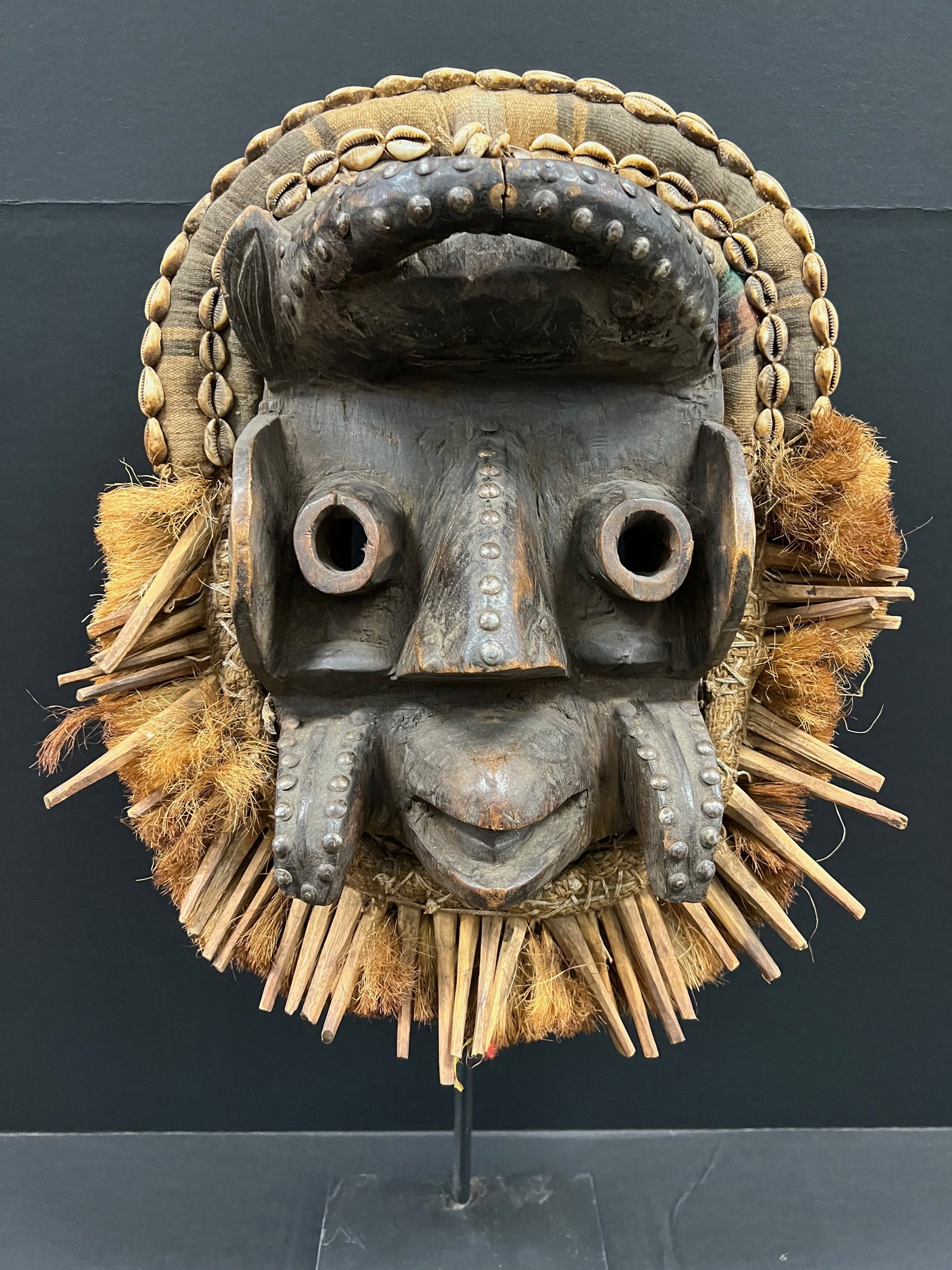 African Tribal Art Carved Wood Dan Guere Mask with Display Stand: Title: Dan Guere Mask with Display Stand Date/Period: Late 20th Century Materials: Wood Size: 17" h x 14" w Reserve: $500.00 Shipping: Domestic: Flat-rate of $60.00 to anywhere within the contiguous U