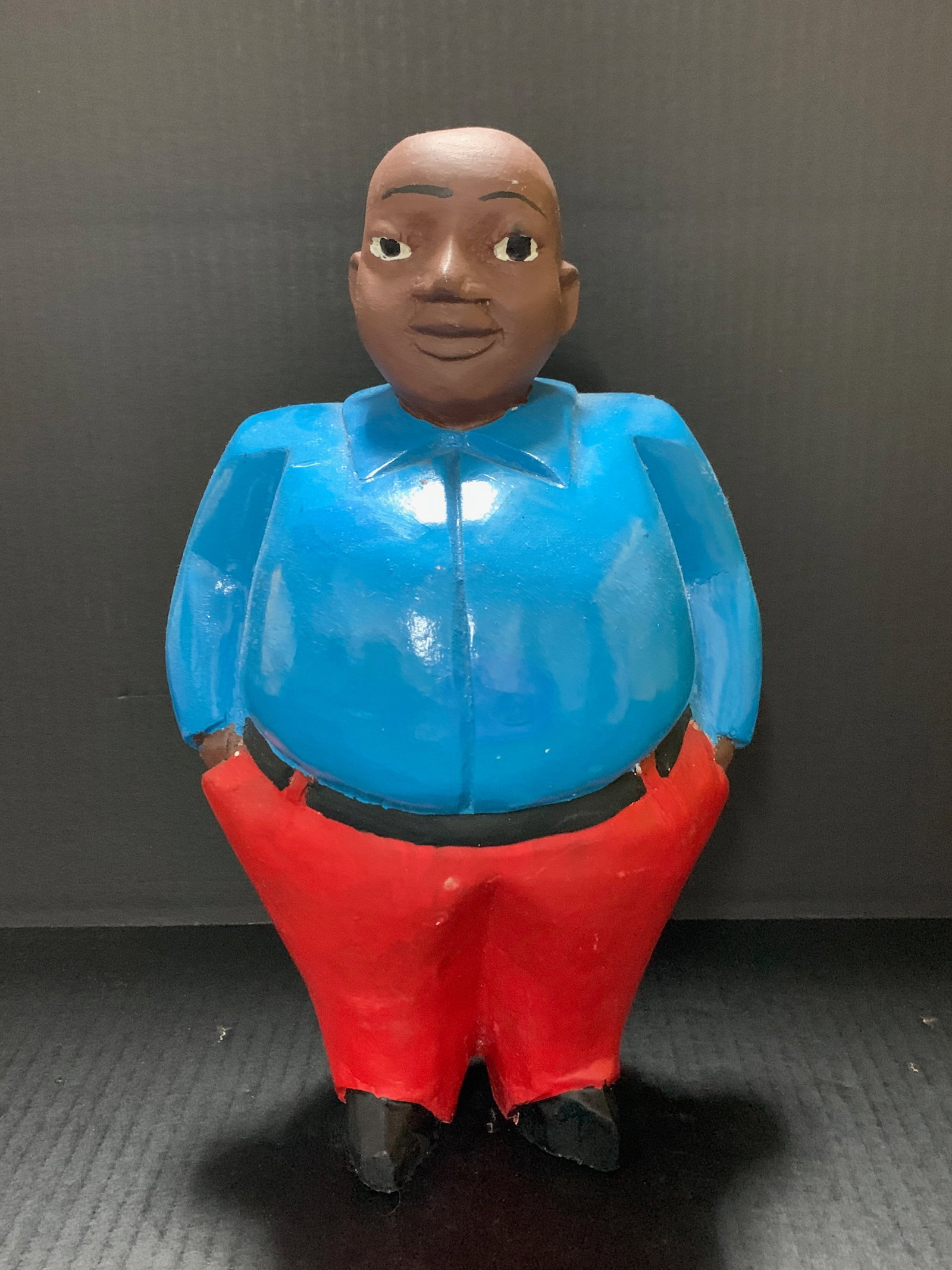 African Tribal Art Carved Wood Colonial Male Statue: Title: Colonial Male Statue Date/Period: Late 20th Century Materials: Wood Size: 13" h x 7.5" w Reserve: $80.00 Shipping: Domestic: Flat-rate of $30.00 to anywhere within the contiguous U.S.