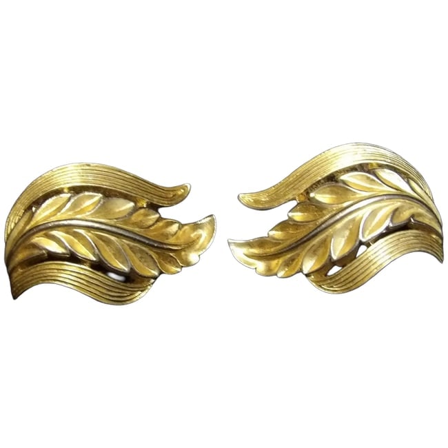 Mid-Century Trifari Gold Tone Leaf Clip on Earrings- Rare Design: This pair of Mid-Century Trifari Gold Tone Leaf Clip on Earrings is a hard-to-find design. They measure 1 1/8" x 5/8"- clips are still strong. Trifari is one of the highest quality producers of