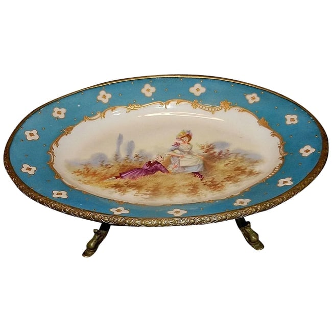 Antique Victorian Hand Painted Porcelain Plate with Ormolu Trim Serves Style: There are just no words to really describe this Antique Victorian Hand Painted Porcelain Plate with Ormolu Trim and Dolphin Footed Base. The plate is adorned with a charming couple mounted in gilt-bro