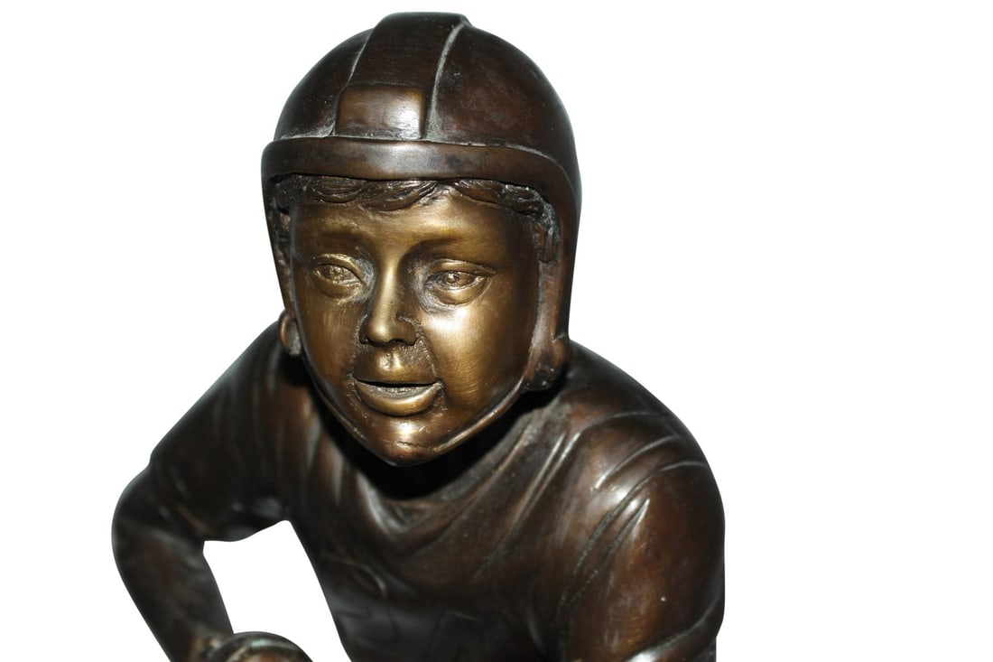Boy playing football Bronze Statue - Size: 10"L x 8"W x 20"H. - 2