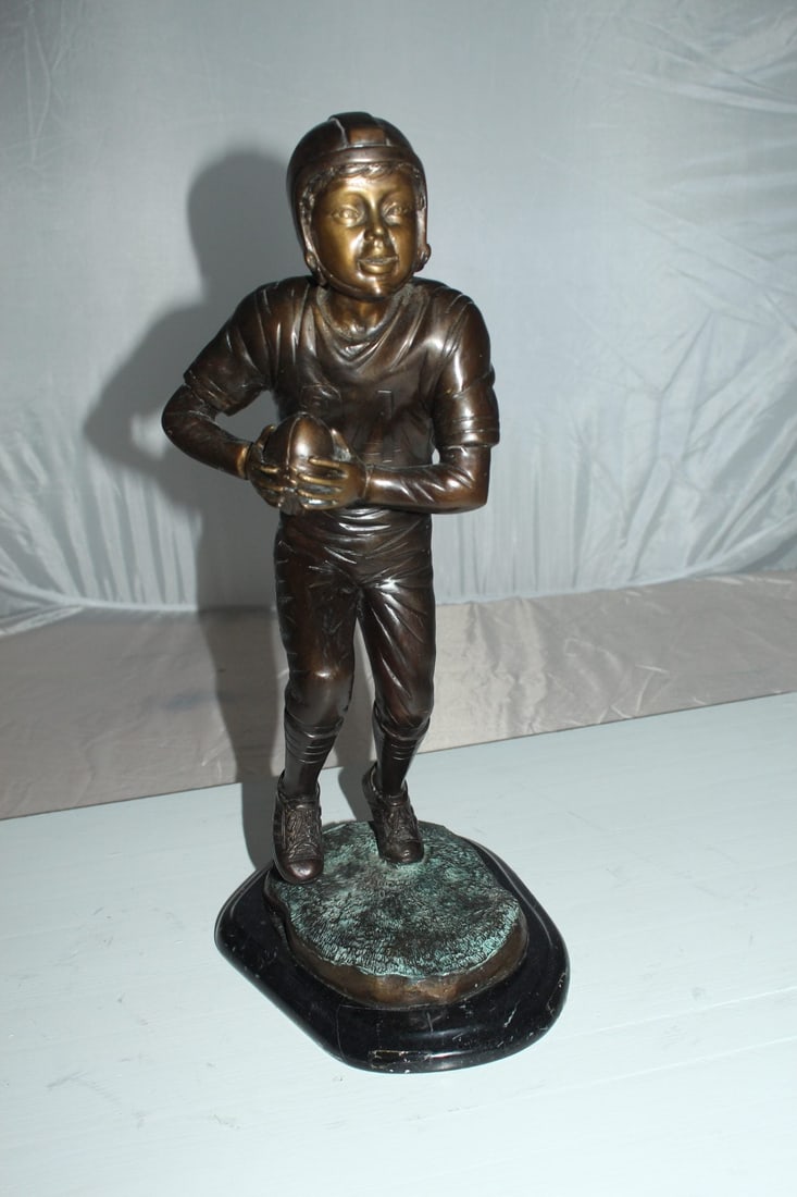 Boy playing football Bronze Statue - Size: 10"L x 8"W x 20"H. - 3