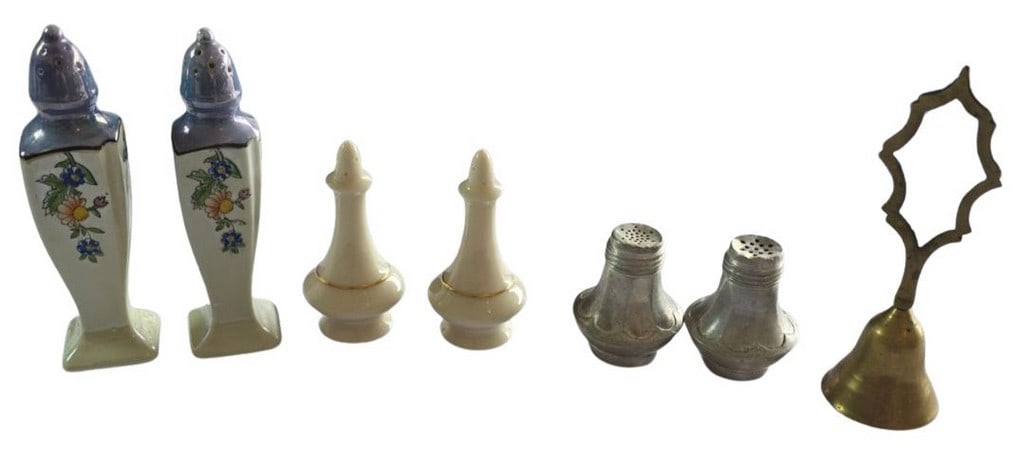 Collection of Vintage Salt and Pepper Shakers with a Brass Bell: This lot features a charming collection of vintage salt and pepper shakers, alongside a decorative brass bell. The first pair of shakers are crafted from ceramic with a delightful floral motif on a