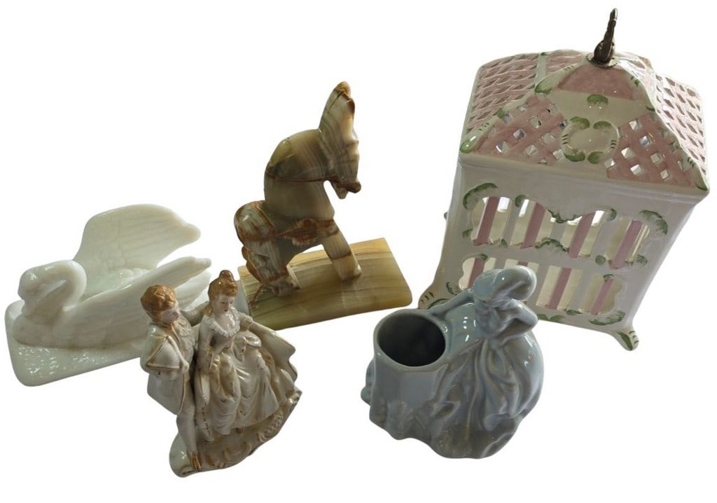 Collection of Decorative Figurines and Trinket Box: This lot features a charming collection of decorative items, including a white milk glass swan dish, a porcelain figurine of a courting couple, an onyx horse sculpture, a ceramic trinket box with a re