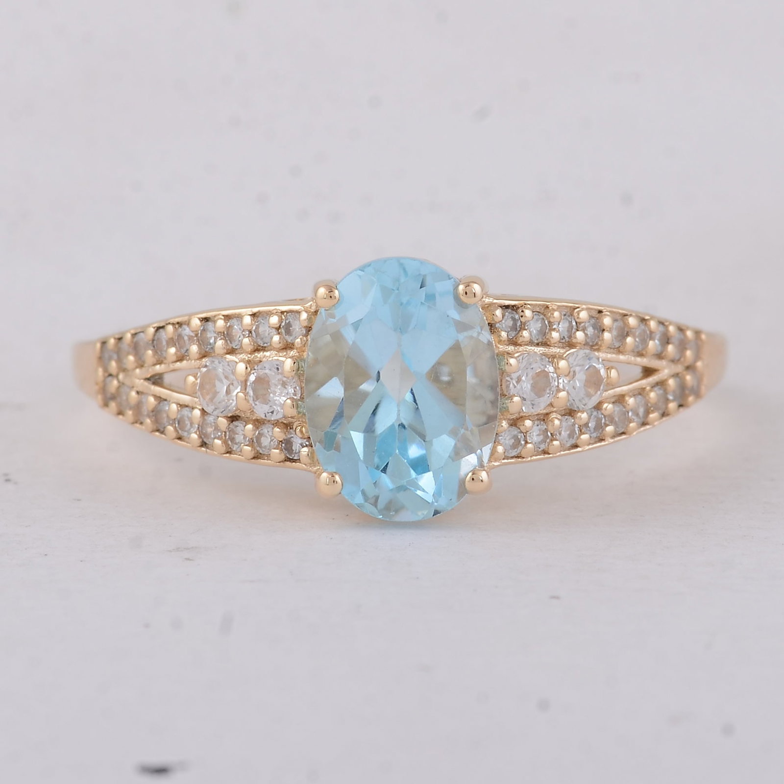 1.75 Ct Oval Blue Topaz 9K Gold Ring: 1.75 Total Carat Blue Topaz 9K Gold Ring Specifications: Total Weight 2.13 g Center Gemstone Blue Topaz Gemstone Carat Weight 1.47 Carats Gemstone Measurements 8X6 mm Additional Gemstones White