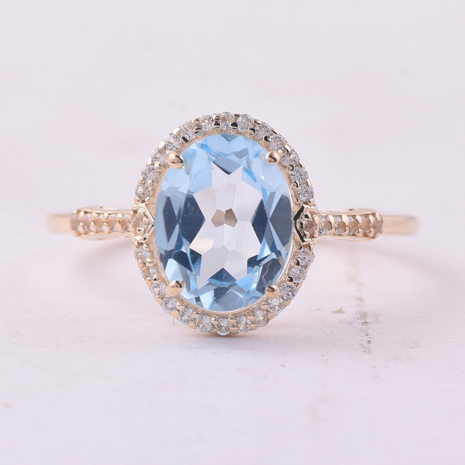 2.24 Ct Oval Blue Topaz 9K Gold Ring: 2.24 Total Carat Blue Topaz 9K Gold Ring Specifications: Total Weight 1.813 g Center Gemstone Blue Topaz Gemstone Carat Weight 2.08 Carats Gemstone Measurements 9X7 mm Additional Gemstones White
