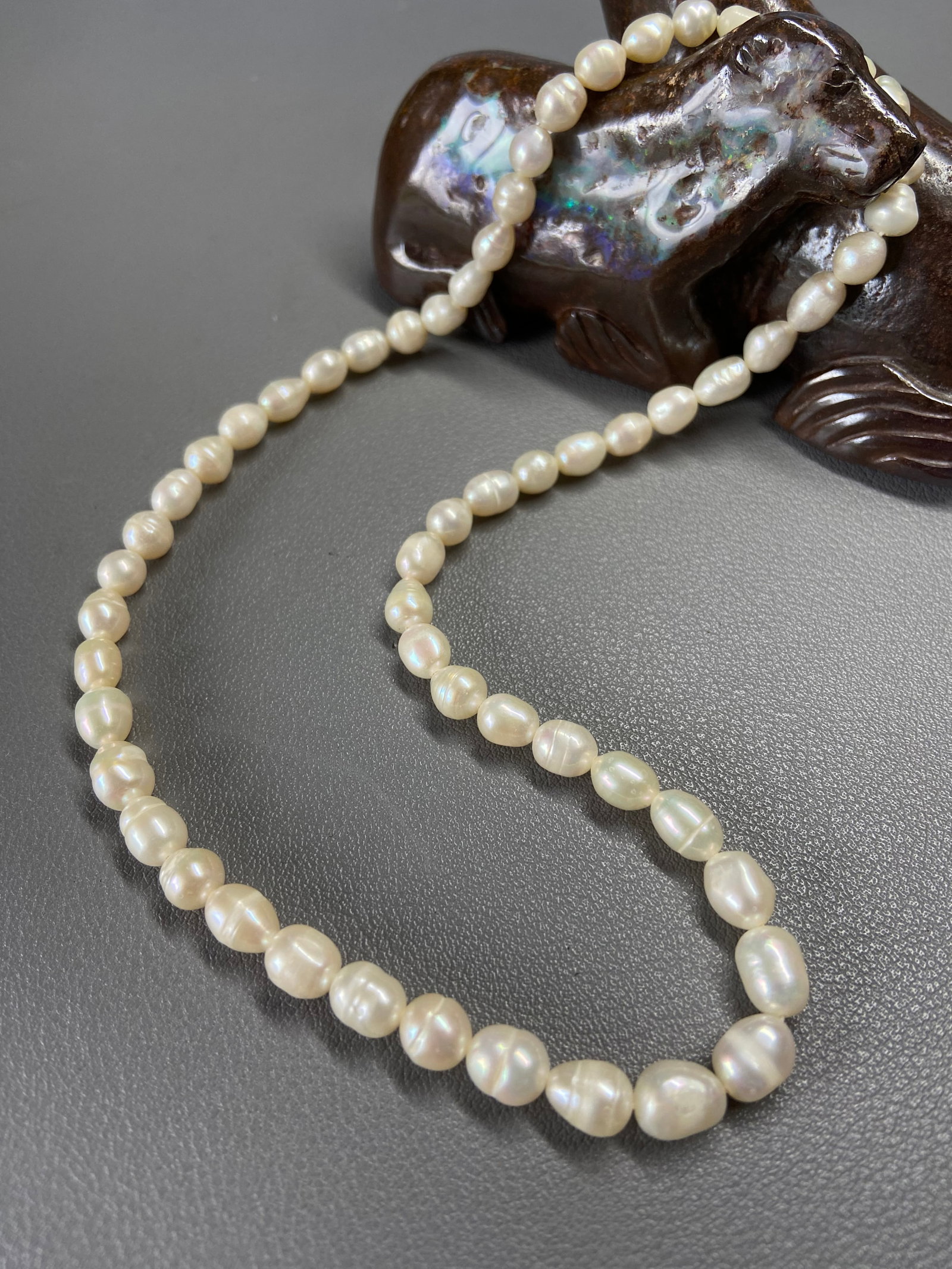 Vintage Graduated Freshwater Pearl Necklace: Title: Vintage Graduated Freshwater Pearl Necklace Description:A delicate vintage graduated freshwater pearl necklace showcasing a timeless and natural elegance. The pearls exhibit visible growth