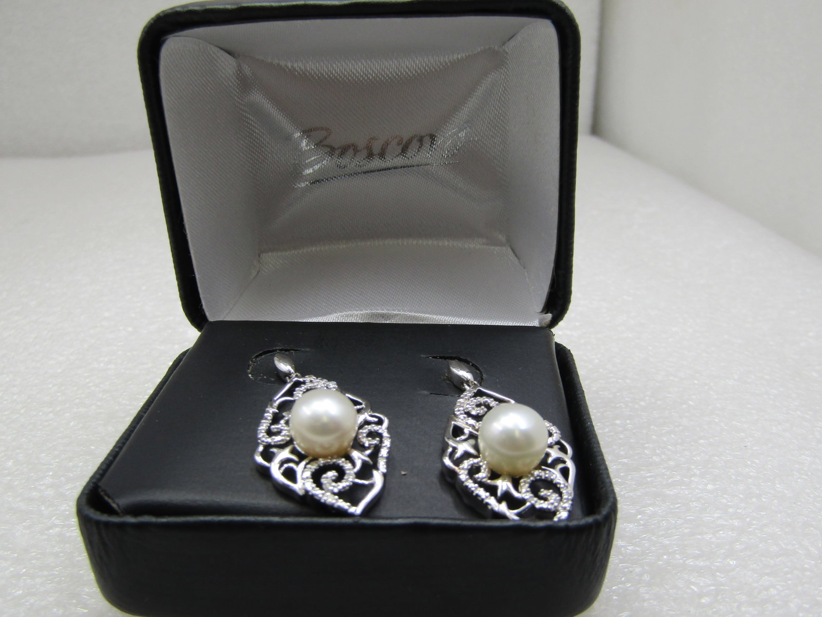 Sterling Pearl and Diamond Filigree Drop Earrings, Pierced. 8mm, .10 ctw: Title:Sterling Pearl and Diamond Filigree Drop Earrings, Pierced. 8mm, .10 ctw Description:Sterling Pearl and Diamond Filigree Drop Earrings, Pierced. 8mm, .10 ctwThey have a cat-eye shaped stud from