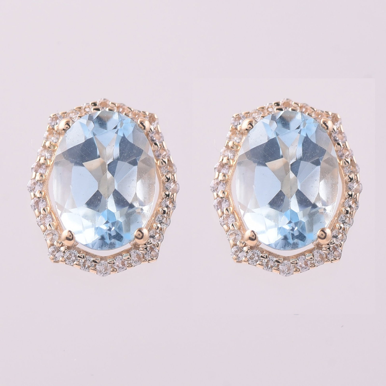 3.14 Ct Oval Blue Topaz 9K Gold Earrings: 3.14 Total Carat Blue Topaz 9K Gold Earrings Specifications: Total Weight 1.84 g Center Gemstone Blue Topaz Gemstone Carat Weight 2.89 Carats Gemstone Measurements 8X6 mm Additional Gemstones White Sa