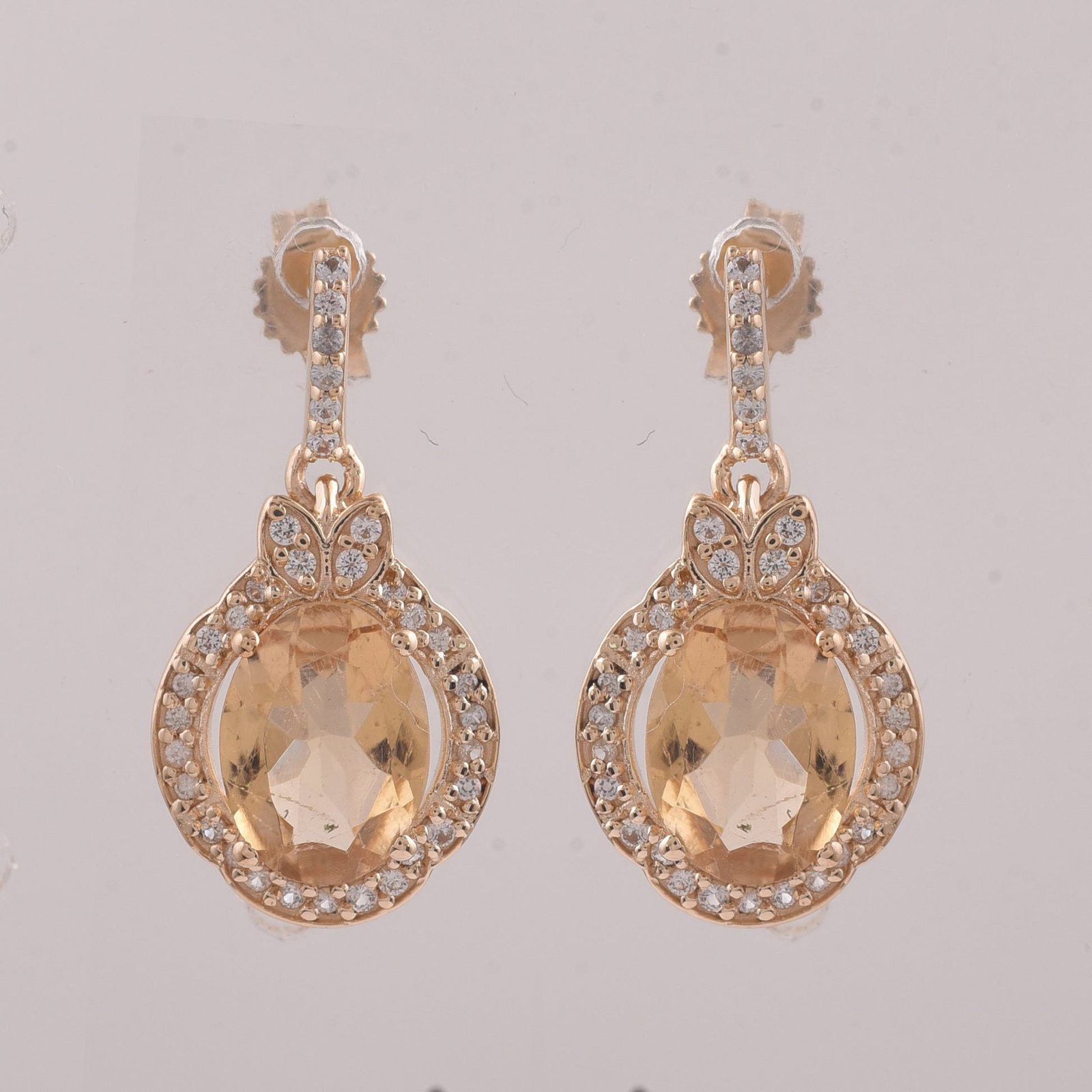 2.34 Ct Oval Tourmaline 9K Gold Earrings: 2.34 Total Carat Tourmaline 9K Gold Earrings Specifications: Total Weight 2.319 g Center Gemstone Tourmaline Gemstone Carat Weight 2.07 Carats Gemstone Measurements 8X6 mm Additional Gemstones White