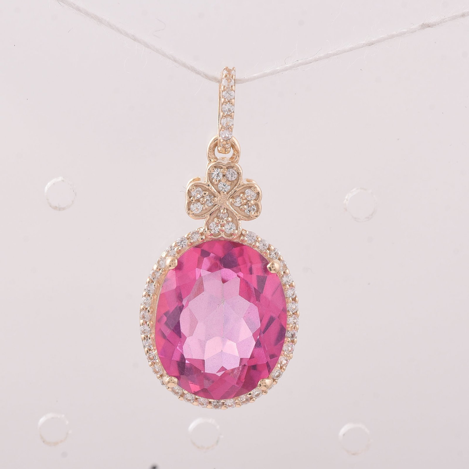 6.52 Ct Oval Pink Topaz 9K Gold Pendant: 6.52 Total Carat Pink Topaz 9K Gold Pendant Specifications: Total Weight 2.388 g Center Gemstone Pink Topaz Gemstone Carat Weight 6.3 Carats Gemstone Measurements 12X10 mm Additional Gemstones White