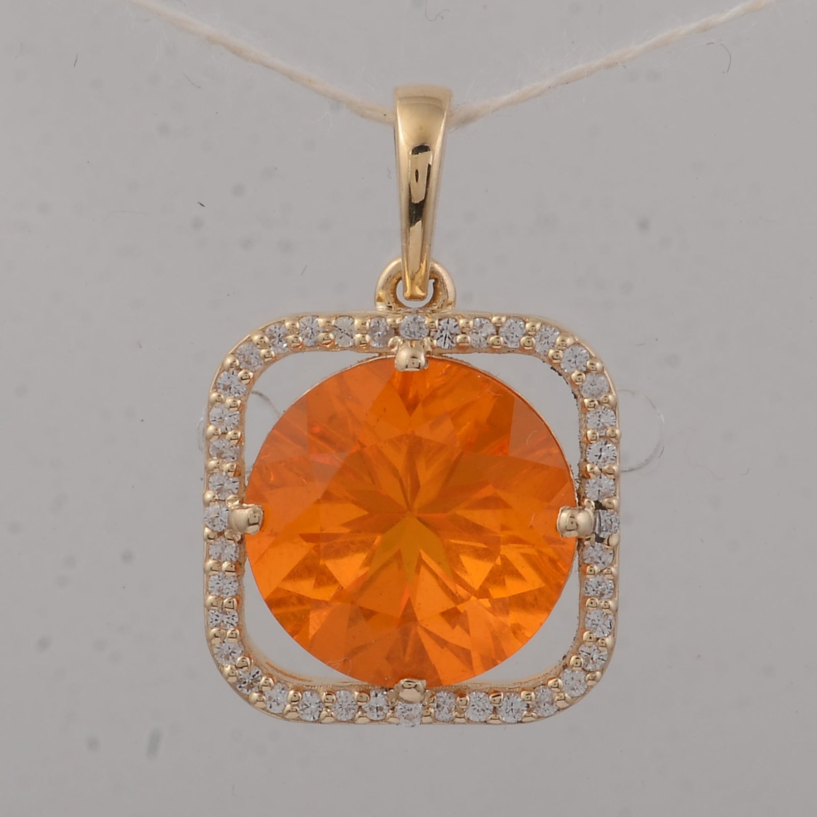 2.59 Ct Round Fire Opal 9K Gold Pendant: 2.59 Total Carat Fire Opal 9K Gold Pendant Specifications: Total Weight 1.69 g Center Gemstone Fire Opal Gemstone Carat Weight 2.41 Carats Gemstone Measurements 10X10X7 mm Additional Gemstones White S