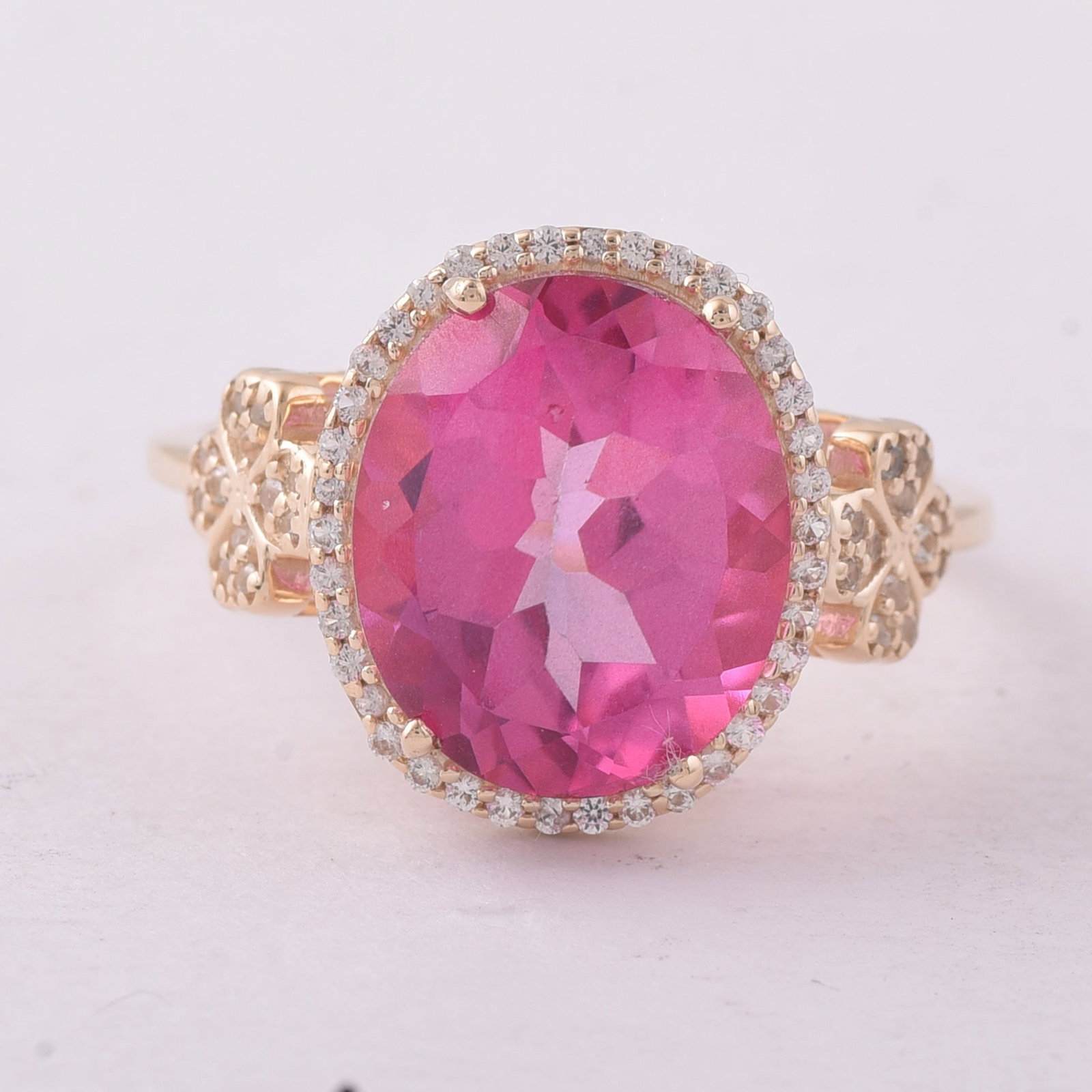 5.73 Ct Oval Pink Topaz 9K Gold Ring: 5.73 Total Carat Pink Topaz 9K Gold Ring Specifications: Total Weight 3.336 g Center Gemstone Pink Topaz Gemstone Carat Weight 5.49 Carats Gemstone Measurements 12X10 mm Additional Gemstones White
