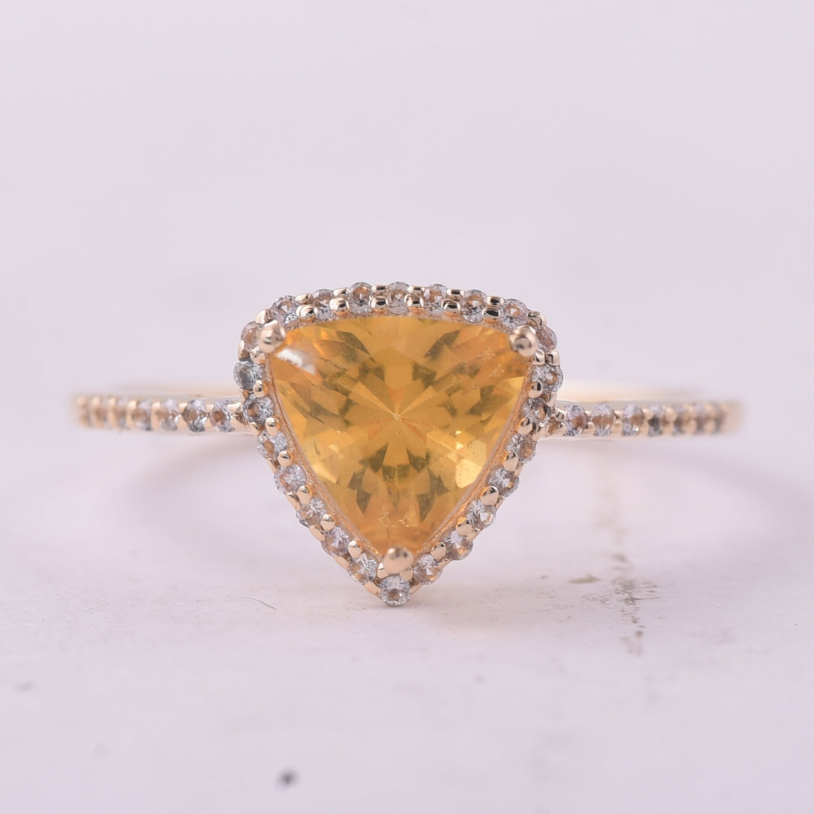0.77 Ct Trillion Br.Fire Opal 9K Gold Ring: 0.77 Total Carat Br.Fire Opal 9K Gold Ring Specifications: Total Weight 1.439 g Center Gemstone Br.Fire Opal Gemstone Carat Weight 0.6 Carats Gemstone Measurements 7X7 mm Additional Gemstones White Sa