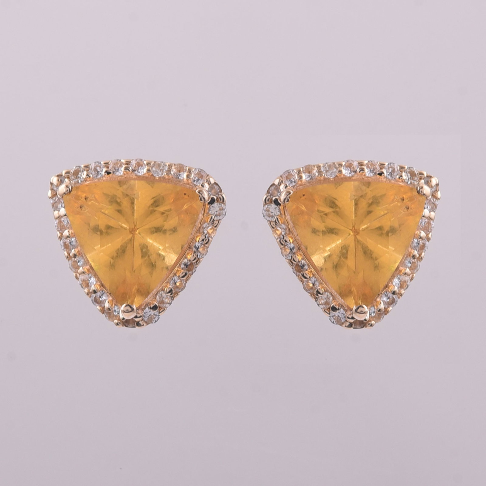 1.56 Ct Trillion Br.Fire Opal 9K Gold Earrings: 1.56 Total Carat Br.Fire Opal 9K Gold Earrings Specifications: Total Weight 1.363 g Center Gemstone Br.Fire Opal Gemstone Carat Weight 1.36 Carats Gemstone Measurements 7X7 mm Additional Gemstones Whi