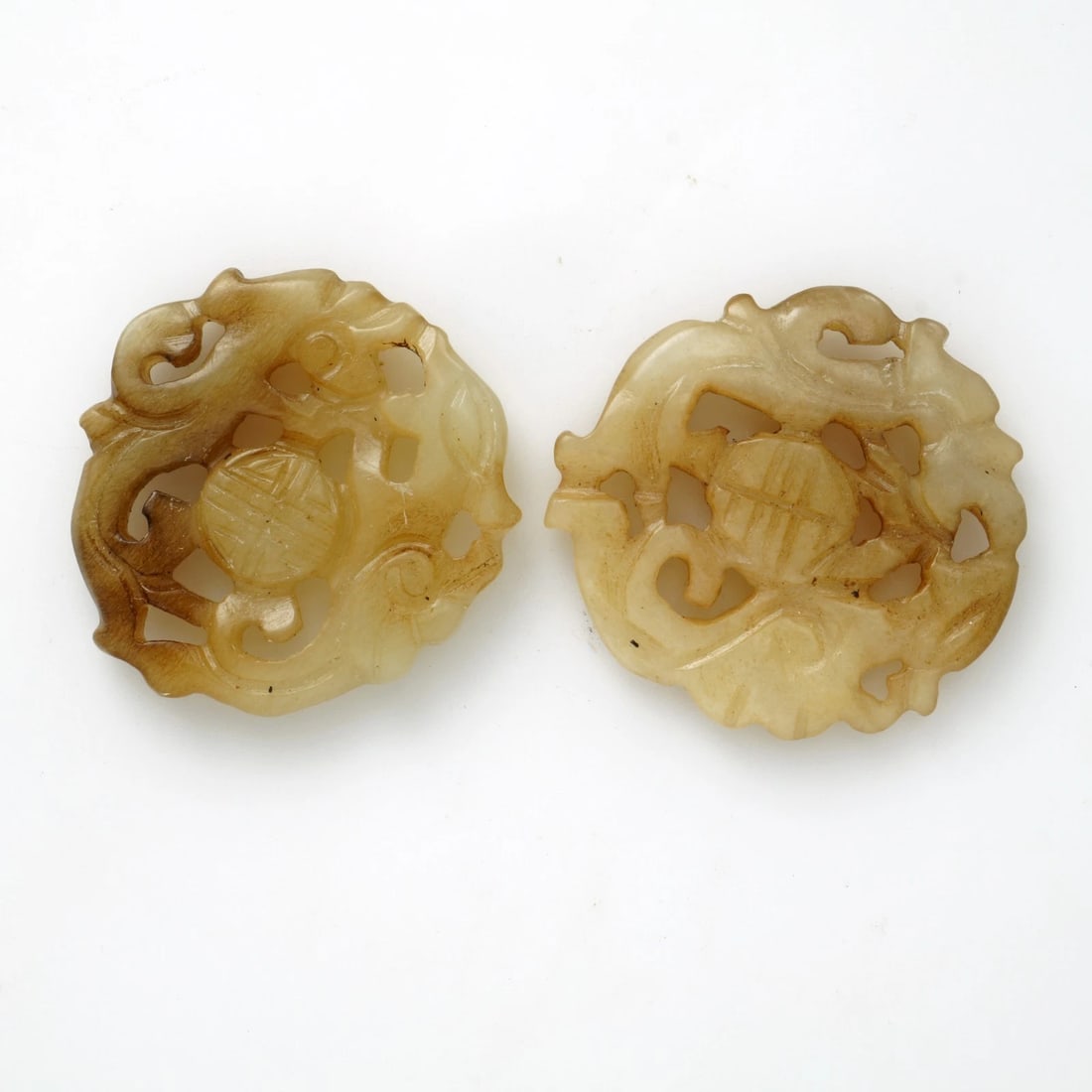 Pair VTG Chinese Carved Medallion Amulets: Title:Pair VTG Chinese Carved Medallion Amulets Size:1 1/8 in (2.9 cm) diameter x 3/32 in (.2 cm) thick. Description:A pair of round, reticulated soapstone medallions with the shou character that can 