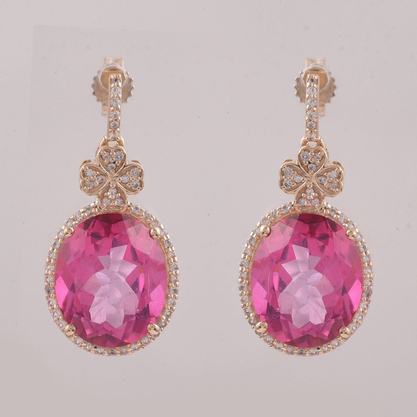 12.82 Ct Oval Pink Topaz 9K Gold Earrings: 12.82 Total Carat Pink Topaz 9K Gold Earrings Specifications: Total Weight 5.192 g Center Gemstone Pink Topaz Gemstone Carat Weight 12.4 Carats Gemstone Measurements 12X10 mm Additional Gemstones Whit