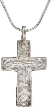 EASTERN EUROPEAN CHRISTIAN CROSS, C. 17TH-18TH CENTURY: Silvered bronze, 2 1/2” height including the suspension loop. Raised edge with the cross beam above center. The front with a vacant cross with Cyrillic ciphers at the terminals. Reverse with rai