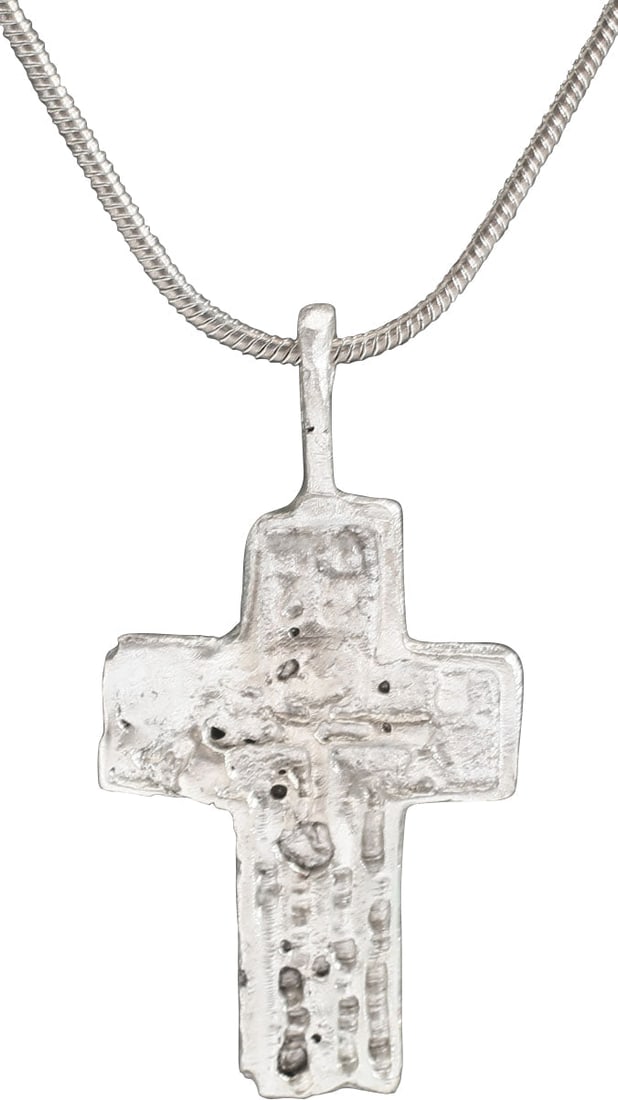 EASTERN EUROPEAN CHRISTIAN CROSS: 17th-18th century, Orthodox rite. Silvered bronze, over 1 1/4" (1.33") in height. Relief decorated. The front with a vacant cross with charges above. Reverse bordered with Cyrillic text as with early 