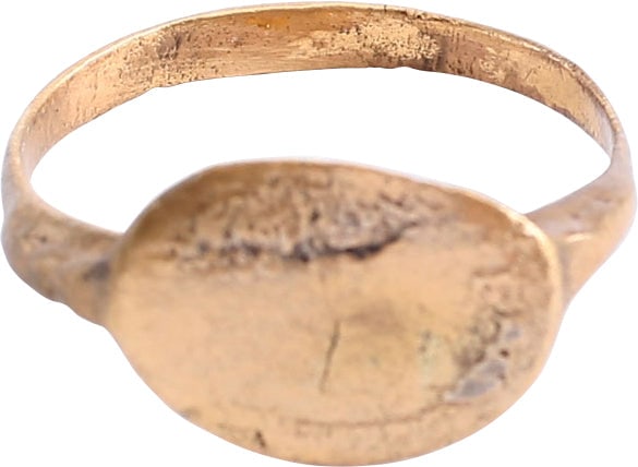 MEDIEVAL EUROPEAN RING, SIZE 9: Fifth to eighth century AD, pre-Viking. Gilt bronze, size 9 with rounded face band, 2.5mm. Raised crested shoulders and oval bezel, probably for the owner to use as a signet. Surface texture from buri