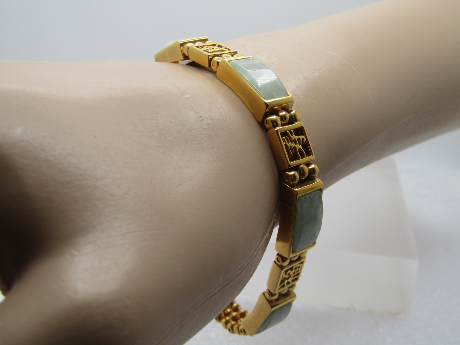 Vintage Jadeite Bracelet, Chinese Symbols, 7.75", 1990's: Title: Vintage Jadeite Bracelet, Chinese Symbols, 7.75", 1990's Description: Vintage Jadeite Bracelet, Chinese Symbols, 7.75", 1990's. Gold tone bracelet with curved mint green jadeite links that are 