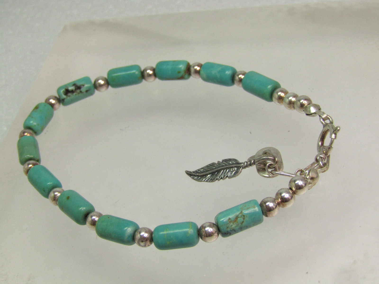 Sterling Carolyn Pollack Turquoise Bracelet, Feather Charm, Southwestern, 1990's. 8.5": Title: Sterling Carolyn Pollack Turquoise Bracelet, Feather Charm, Southwestern, 1990's. 8.5" Description: Sterling Carolyn Pollack Turquoise Bracelet, Feather Charm, 1990's. 8.5". Southwestern. This