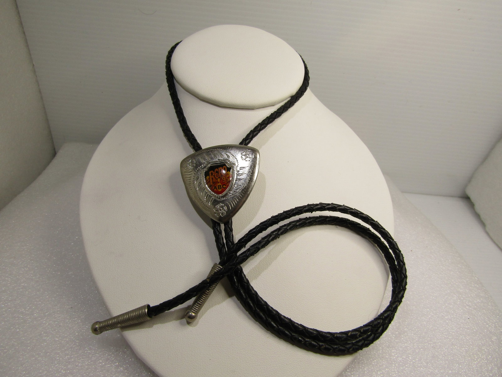 Vintage 1995 ABC Reno Bowling Bolo Tie, 34": Title: Vintage 1995 ABC Reno Bowling Bolo Tie, 34" Description: Vintage 1995 ABC Reno Bowling Bolo Tie, 34" - braided black appx. 3mm leather with silver tone end caps and a designw ith southwestern