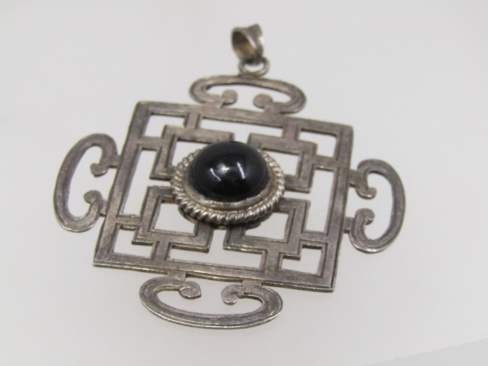 Vintage Sterling Onyx Pendant, Asian/Bali Themed, 2-3/8": Title: Vintage Sterling Onyx Pendant, Asian/Bali Themed, 2-3/8" Description: Vintage Sterling Onyx Pendant, Asian/Bali Themed, 2-3/8" by 2" with a center bezel-set 10.5mm round onyx. swing bail. It te