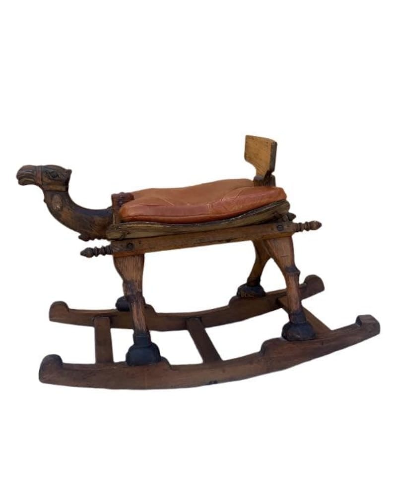 Antique Turkish Camel Rocker: Title: Antique Turkish Camel Rocker Description: .Antique Hand Carved Turkish Wood Camel Rocker with Leather Cushion Seat One of a kind and unique carved wood rocking camel. It’s a child’s
