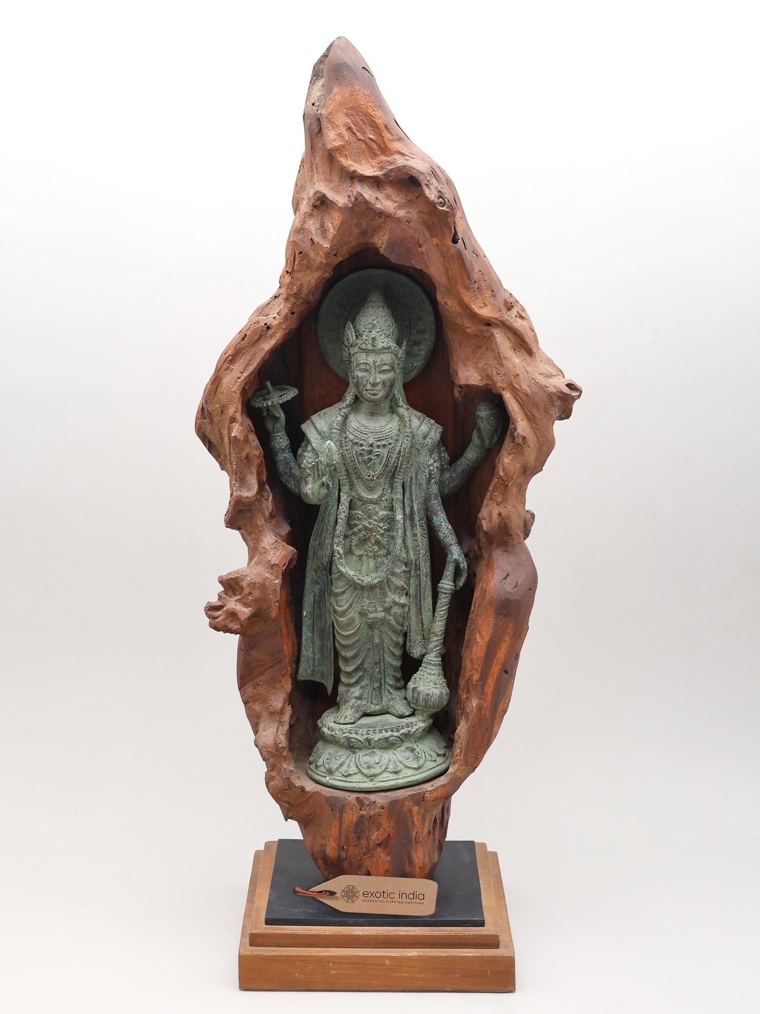 28" Standing Brass Lord Vishnu in Hand-Carved Wooden Grotto: Title: 28" Standing Brass Lord Vishnu in Hand-Carved Wooden Grotto Reserve: $719.00 Shipping: Domestic: Shipping rates are determined by destination International: Foreign shipping rates are determine