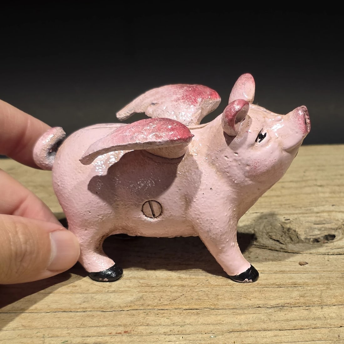 4" Cast Iron Flying Pig Coin Bank: Gemini said Reproduction Cast iron coin bank in the form of a winged flying pig, a whimsical novelty design inspired by early figural banks and folk art humor. Animal-form banks became especially popu
