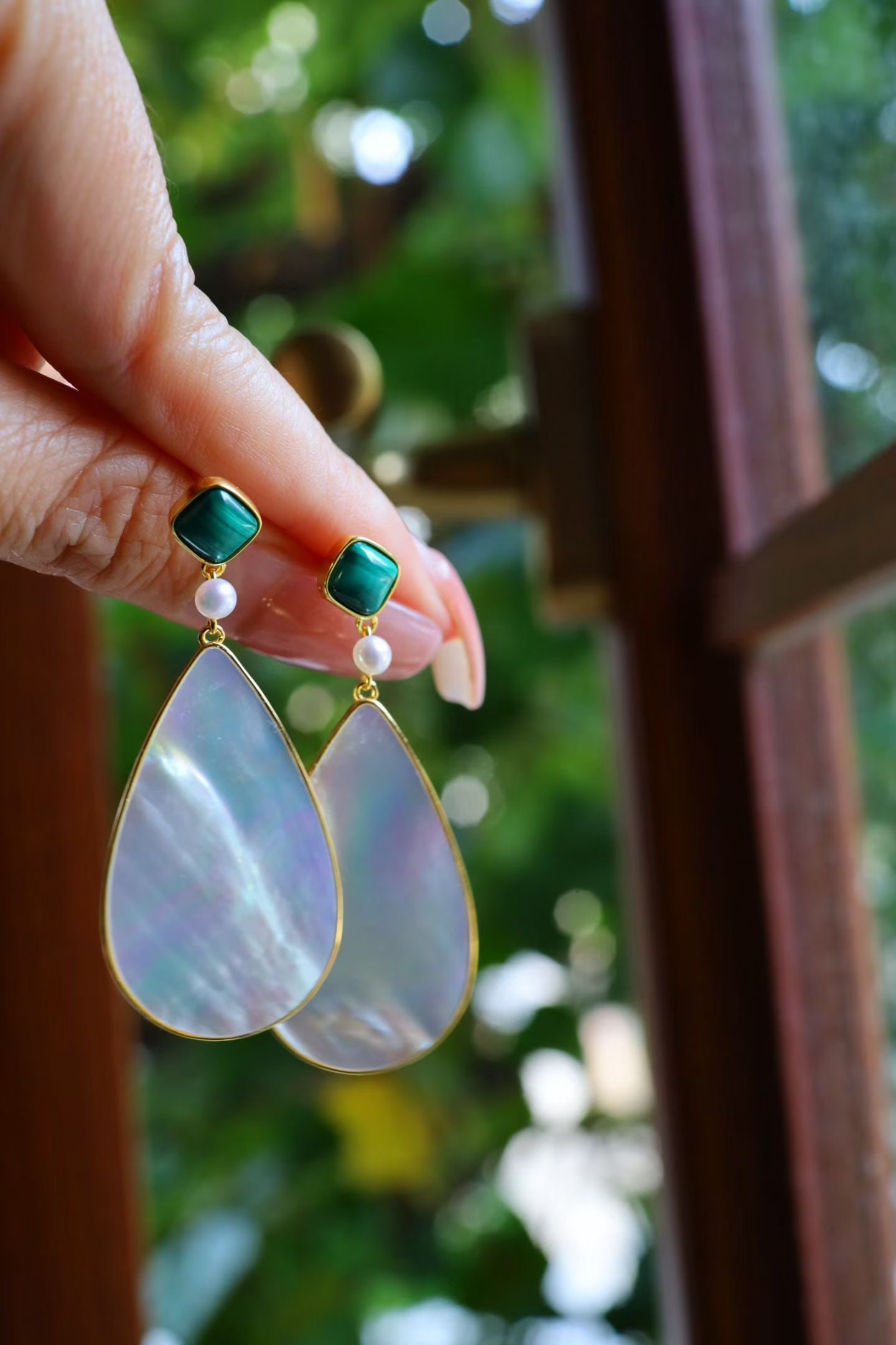 Silver Malachite and White Mother-of-Pearl Earrings: Title: Silver Malachite and White Mother-of-Pearl Earrings Description: The deep green patterns of malachite complement the subtle luster of white mother-of-pearl, creating an unexpectedly harmonious